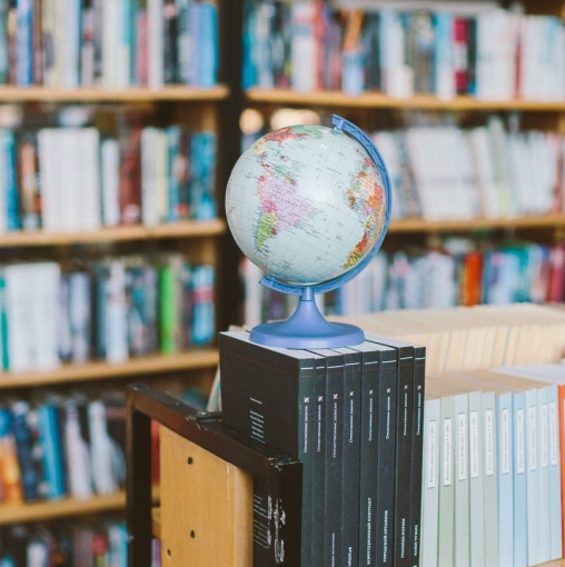 photo of globe on top of books